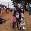 Peter greeted by daughter at finish line