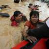 A victim of floodings is rescued in Pasig City , east of Manila . Authorities rushed rescue and relief to thousands of people who spent the night on the roofs of their submerged houses in Manila and surrounding provinces.