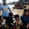 Residents are evacuated by police boats during flooding in Cainta Rizal, east of Manila 