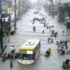 Commuters wade through waist-deep floodwaters after heavy rains dumped by Tropical Storm Ketsana (locally known as Ondoy) on Saturday, Sept. 26, in Manila, Philippines.